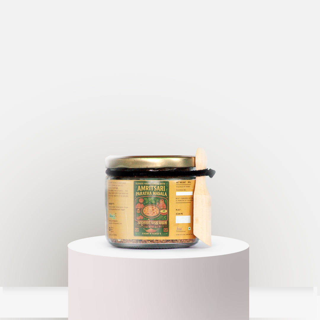 Jar of Amritsari Masala on a white pedestal with a white background
